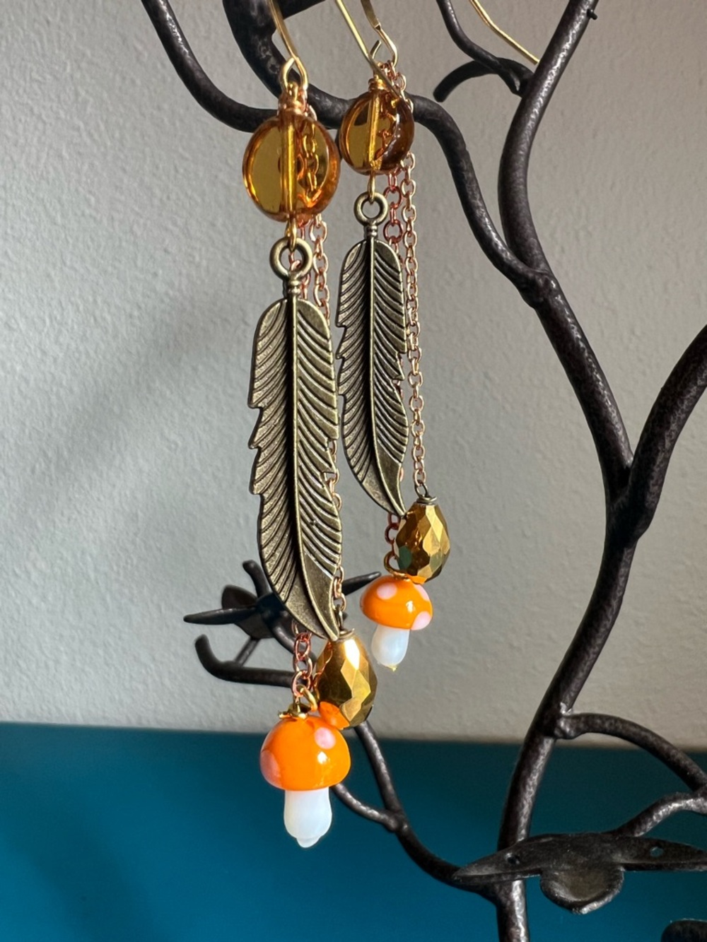 Handmade feather drop earrings Featuring metal